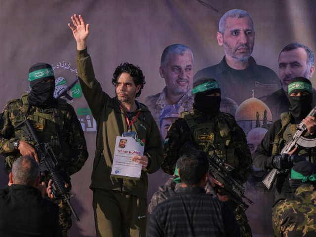 Ofer Kalderon waves before being handed over to the Red Cross. Abdel Kareem/AP